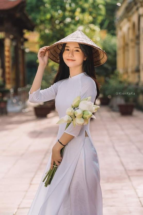 gái xinh cầm hoa sen trắng cười mỉm